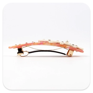 Detail view of pink marble acetate branch hair clip with floral element and pearl