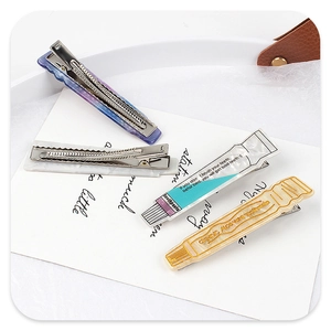 Detailed view of creative toothpaste-shaped acetate hair clips and marble pattern clips