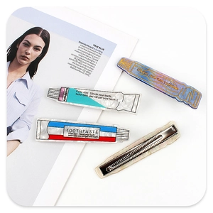 Detail view showing four creative toothpaste-shaped hair clips with marble texture acetate
