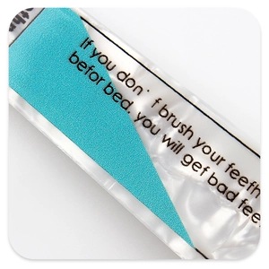 Macro shot of toothpaste shaped hair clip with blue and green translucent patterns