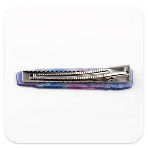 Detail of purple and blue marble pattern acetate hair clip with silver metal duckbill