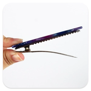Detail view of purple marble pattern acetate hair clip with silver metal alligator grip