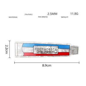 Detailed view of toothpaste shaped acetate hair clip with marble texture and dimensions