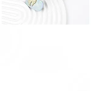 Detailed close-up of a gold metal butterfly hair clip with blue marble textured acetate base
