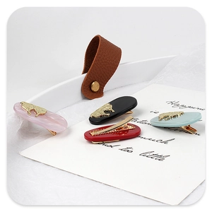 Detailed set of four colorful acetate hair clips with golden metal butterfly ornaments
