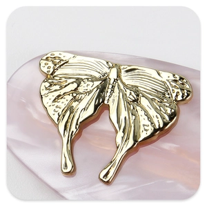 Macro view showing the liquid metal texture of the golden butterfly hair clip for women