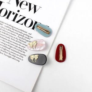Elegant four-piece acetate hair clip set with gold butterfly embossments in four colors