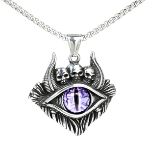 Macro shot of gothic evil eye pendant with skulls and a purple eye on a box chain