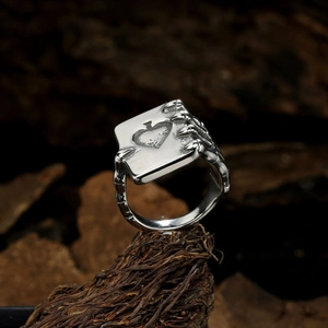 Punk style titanium steel men's ring featuring a poker card held by skeletal bone claws