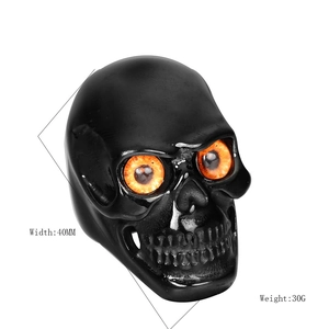 Retro stainless steel skull ring with glowing orange eyes in hardcore gothic style
