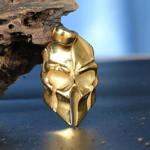 Macro shot of gold spartan helmet skull pendant with rustic wood background