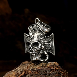 Gothic punk skull and dragon pendant in vintage silver stainless steel on wooden bark