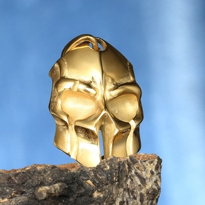 Detailed view of a golden Spartan helmet pendant with high-quality metallic finish and texture