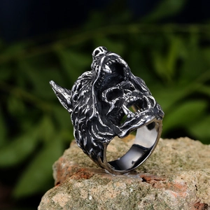 Vintage gothic wolf head skull ring in antique silver finish on a natural rock background