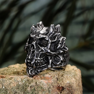 Macro side view of vintage gothic skull ring with flame details on natural stone