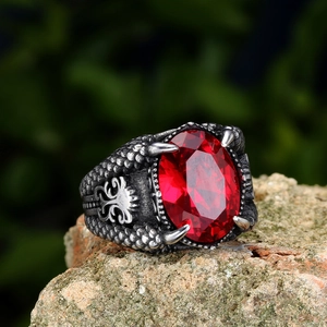 Detailed macro view of the vintage dragon claw ring with a large oval red ruby gemstone