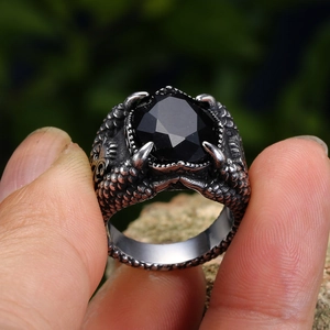 Detailed view of punk dragon claw ring featuring a large faceted black gemstone