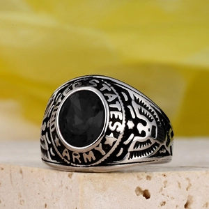 Detail of military ring featuring a black gemstone and United States Army engraving
