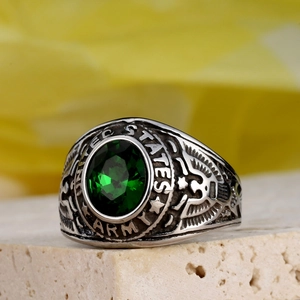 Macro view of US Army signet ring with green gemstone and eagle relief detail