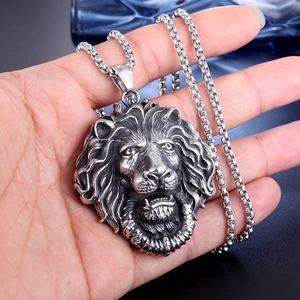Detailed close-up of a vintage stainless steel lion head pendant with intricate mane