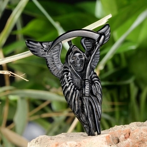 Polished black obsidian grim reaper statue with wings and scythe on natural brick background