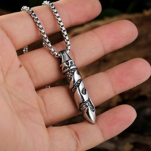 Detail of vintage stainless steel dagger pendant with spiral carvings and square pearl chain