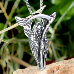 Macro detail of silver death reaper pendant with wings and scythe on a box chain
