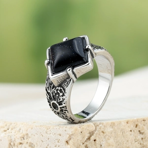 Macro shot of men's stainless steel ring with square blue goldstone in a vintage style