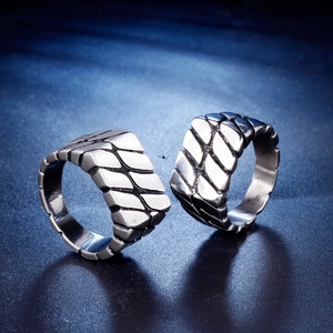 Men's stainless steel rings featuring industrial tire tread pattern and brushed finish