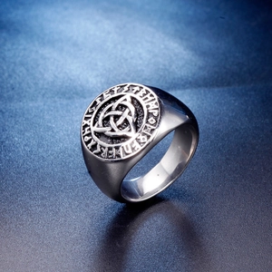 Vintage Viking stainless steel ring with Triquetra knot and Runic letters on a dark background