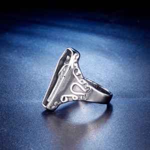 Detailed close-up of gothic stainless steel coffin ring with intricate floral carvings
