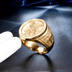 Macro view of gold Saint Michael signet ring with detailed cross relief on the side