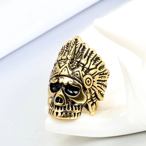 Macro detail of gold plated steel ring featuring an intricate skull chieftain design