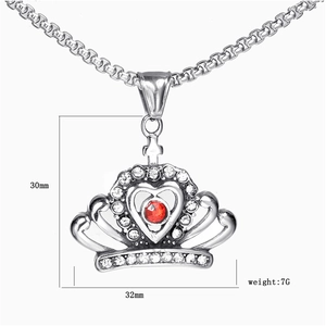 Detail view of crown heart pendant with red gemstone and white rhinestones, 32mm width