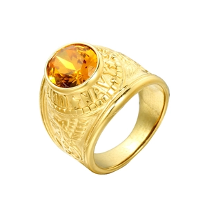 Macro detail of men's gold stainless steel Navy ring with large round yellow gemstone