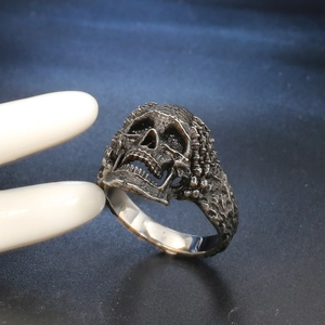 Retro stainless steel skull ring with vintage punk style shown from a side angle