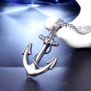 Detail of vintage anchor pendant with rope accent on stainless steel necklace