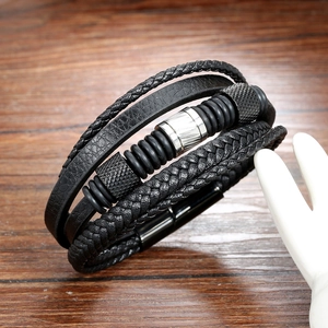 Men's multi-layer black leather braided bracelet with metal beads on wood background
