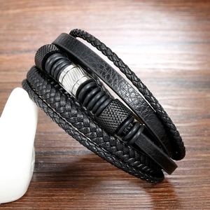 Men's multilayer black braided leather bracelet with stainless steel accents on wood background