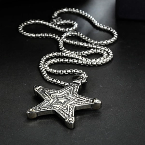 Detail of vintage silver pentagram star pendant with intricate geometric engravings