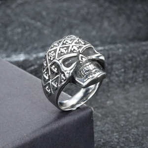 Macro shot of vintage stainless steel skull ring with embossed diamond mesh texture