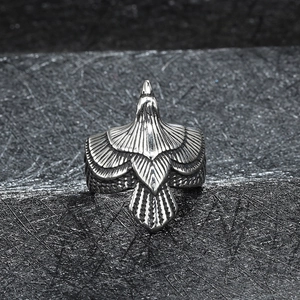 Macro view of detailed eagle feather texture on vintage stainless steel biker ring