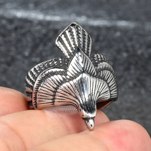 Detailed close-up of a vintage eagle ring with intricate wing feathers and oxidized finish