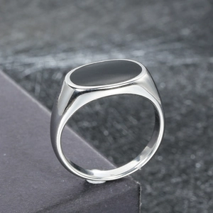 Polished silver stainless steel signet ring with oval black enamel inlay, 45-degree view