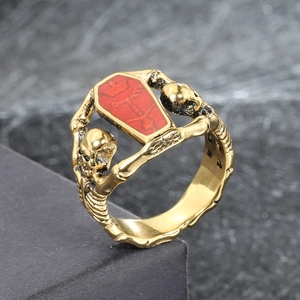 Macro view of gothic skull ring with red coffin panel and gold finish relief