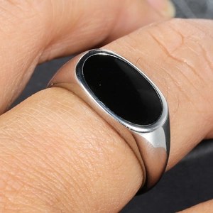 Minimalist silver stainless steel signet ring featuring a polished black oval inlay