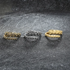 Detailed macro of vintage octopus tentacle open rings in bronze, silver, and gold finishes