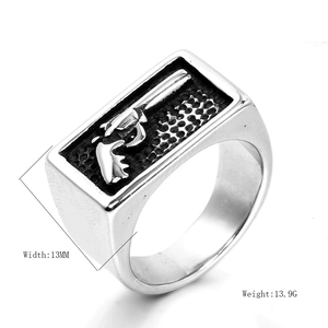 Close-up of men's stainless steel signet ring with a detailed revolver gun relief