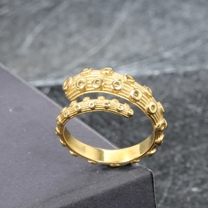Gothic octopus tentacle wrap ring in golden stainless steel finish with sucker detail