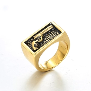 Gold men's punk ring featuring a black honeycomb background and revolver relief design